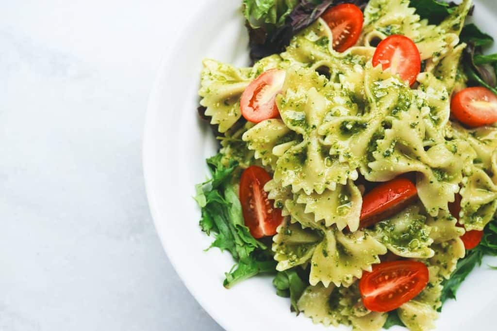 Farfalle pasta with pesto, salad and cherry tomatoes