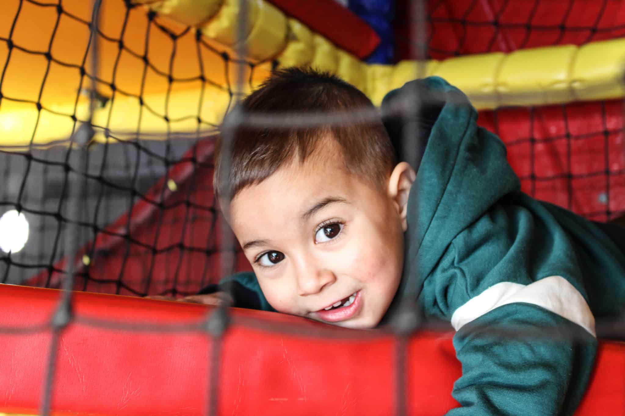 Kid lying down in the soft play area