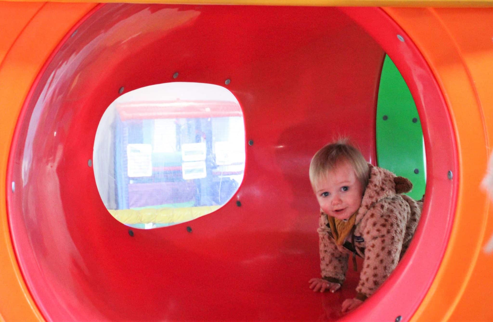 toddler crawling through tunnel at Bewl Water soft play