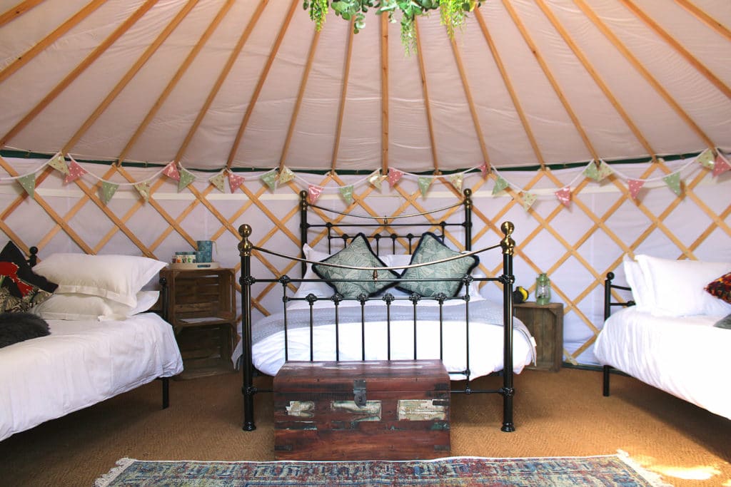 Inside of yurt with three beds