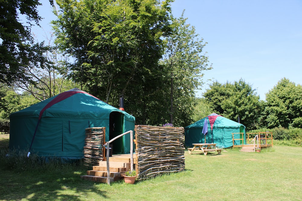 Outside of two blue yurts