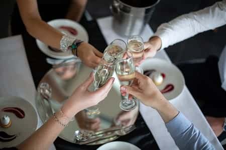 4 people making a toast with champagne