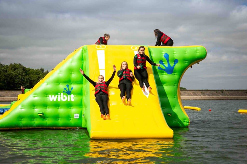People going down a inflatable water slide