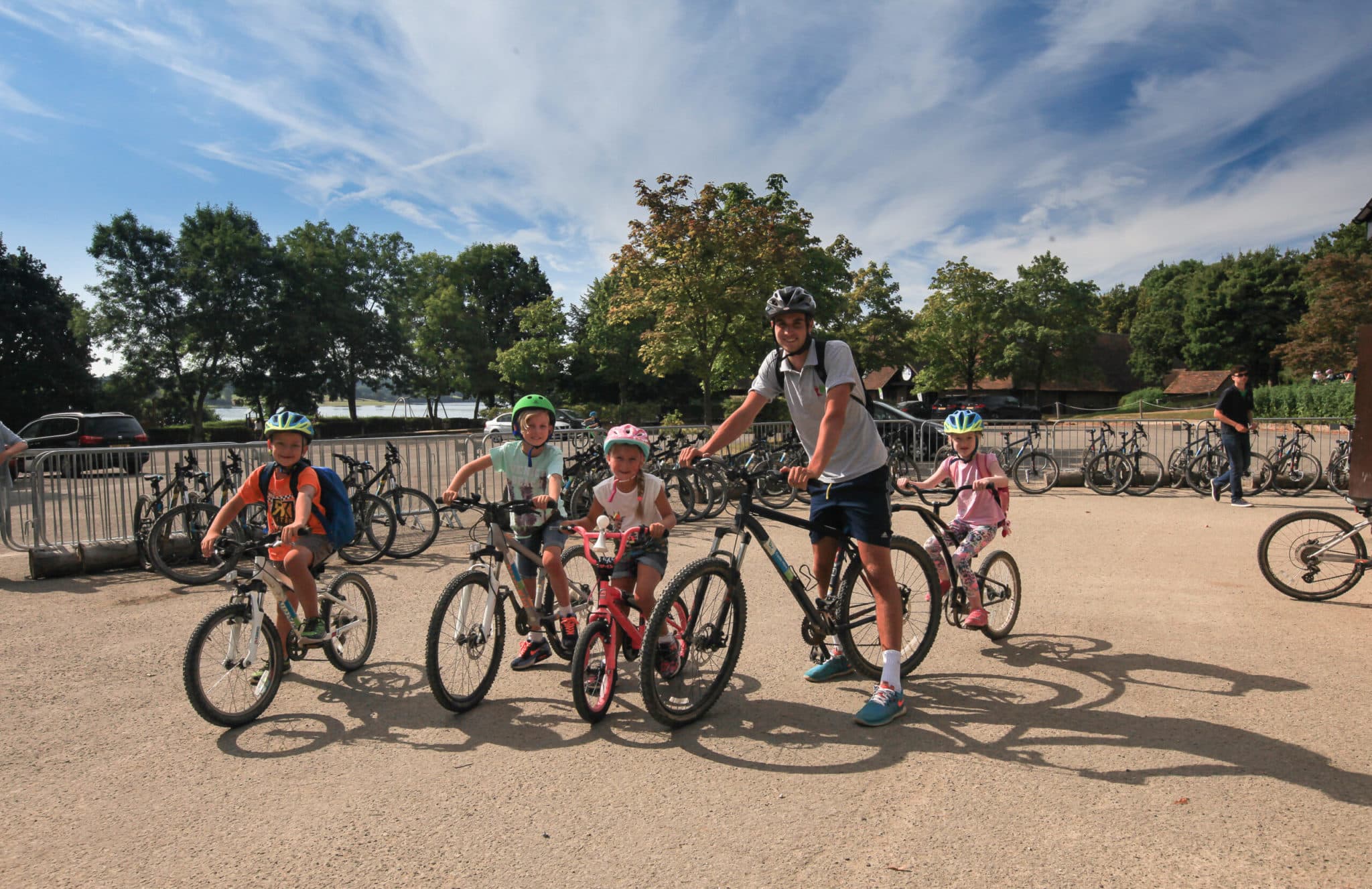 Man and kids on bicycles