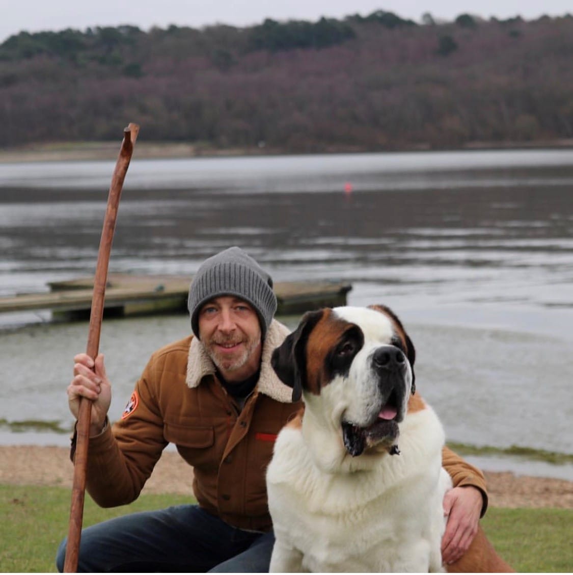 A walker posing with his dog.