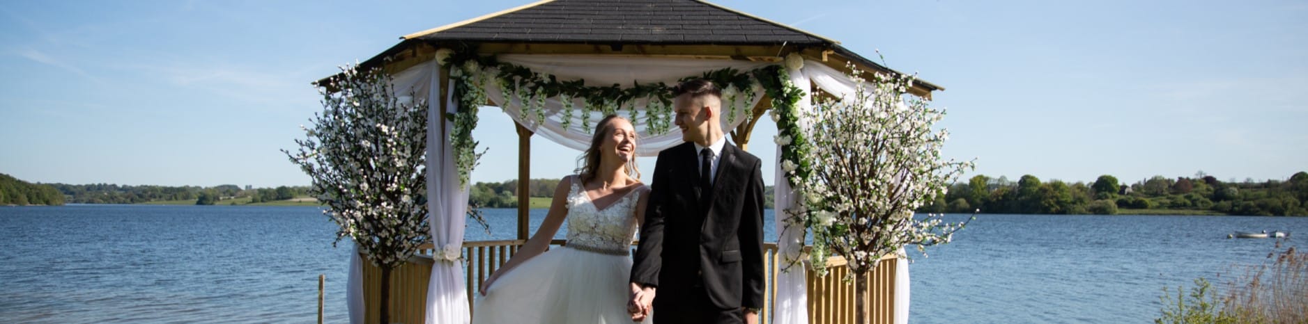 Couple holding hands on their wedding day