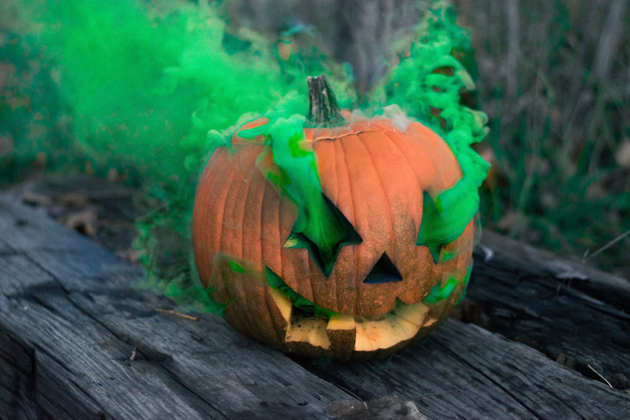Halloween Pumpkin with green smoke coming out of its eyes and mouth