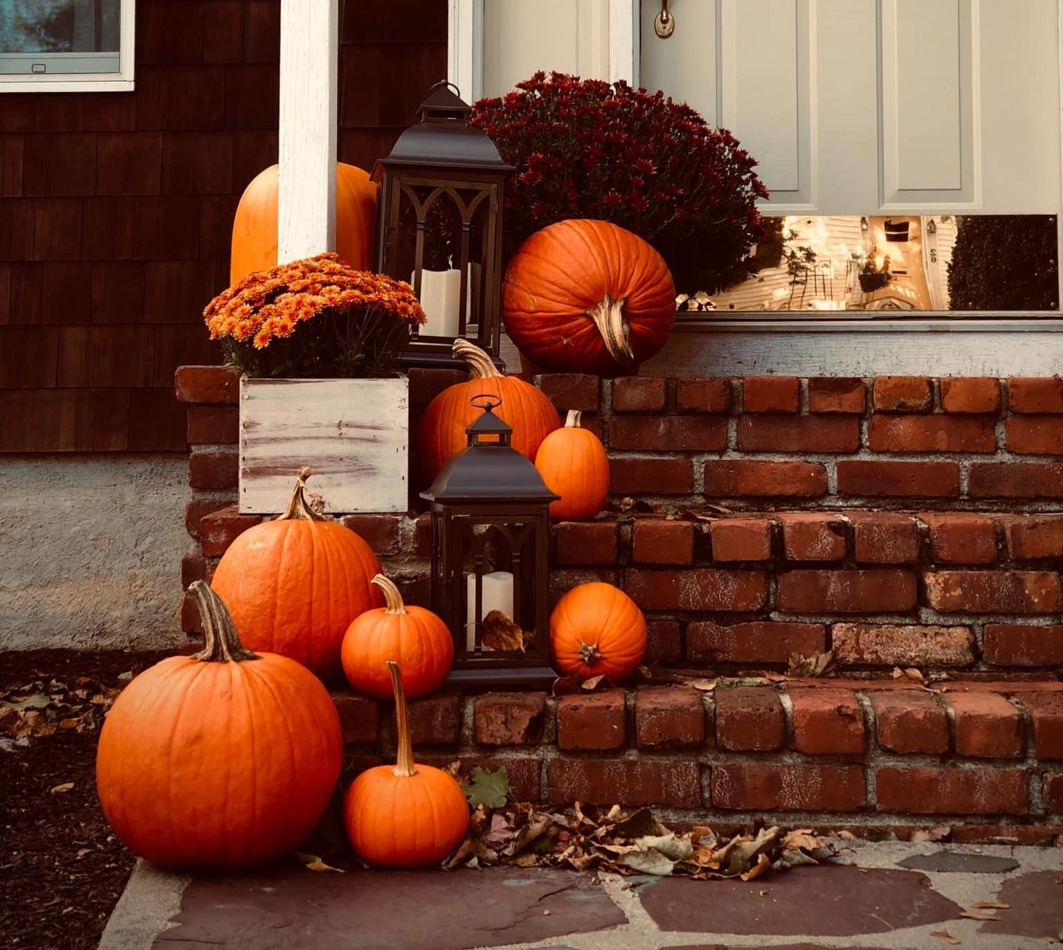 Pumpkins outside a houses porch