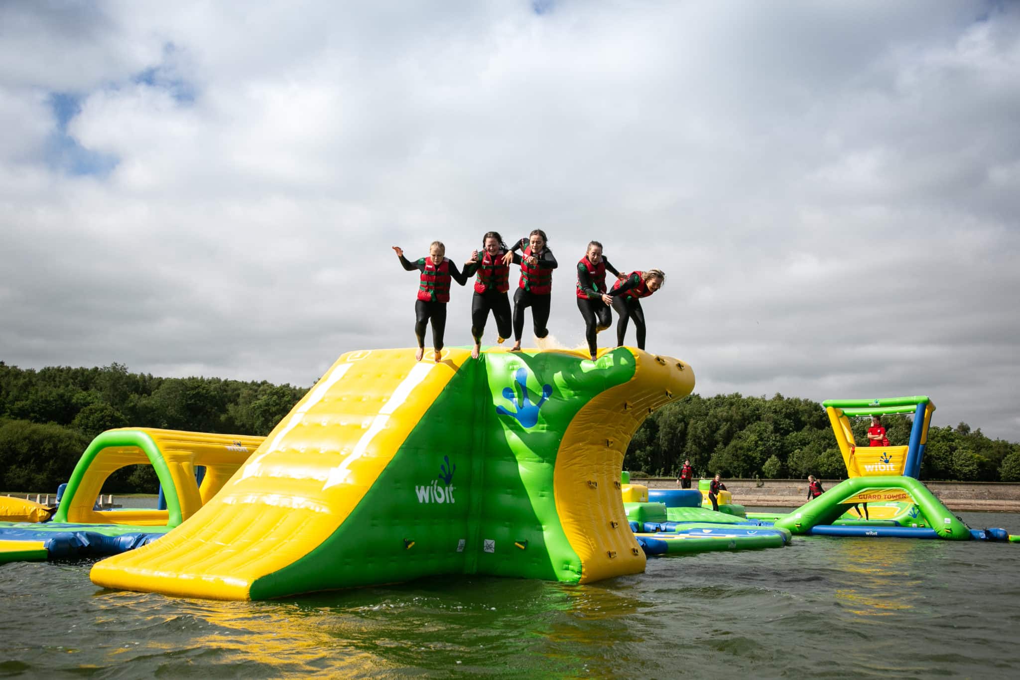 5 people jumping from wibit inflatable
