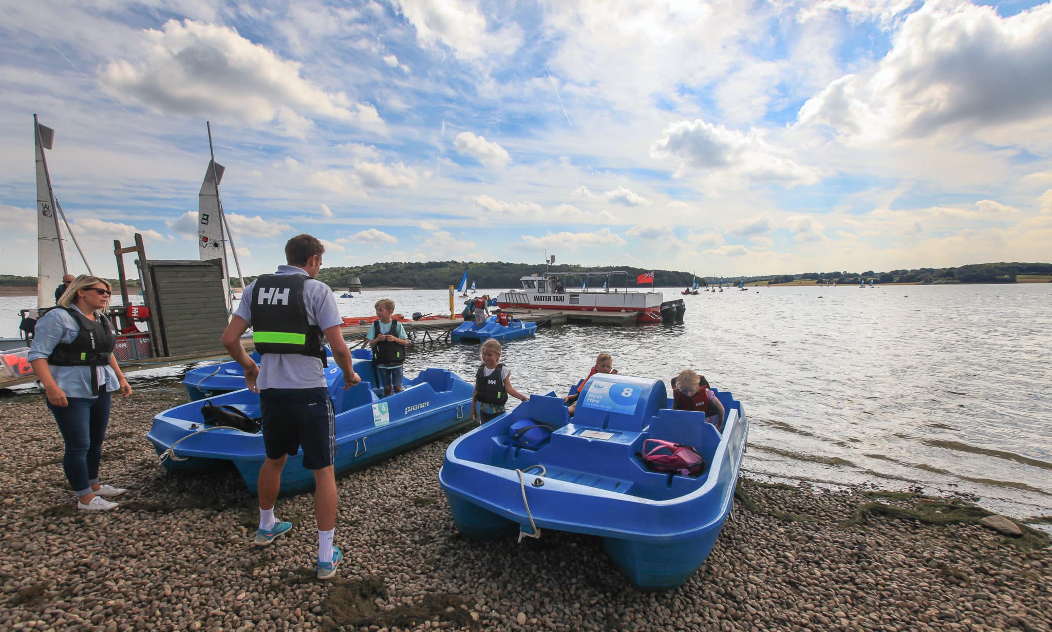 Family preparing to go on pedalos at bewl water