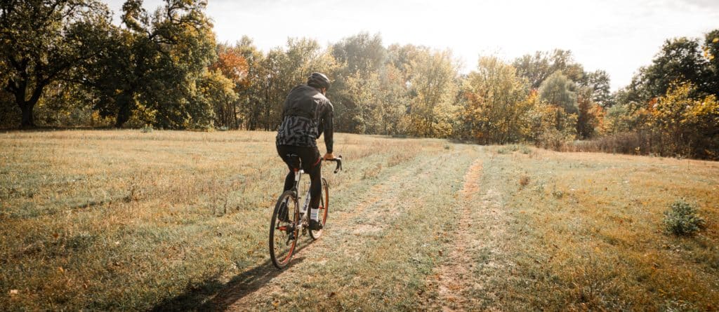 cyclist in open field on a sunny day