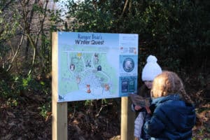 Kids in front of the ranger bears winter quest map