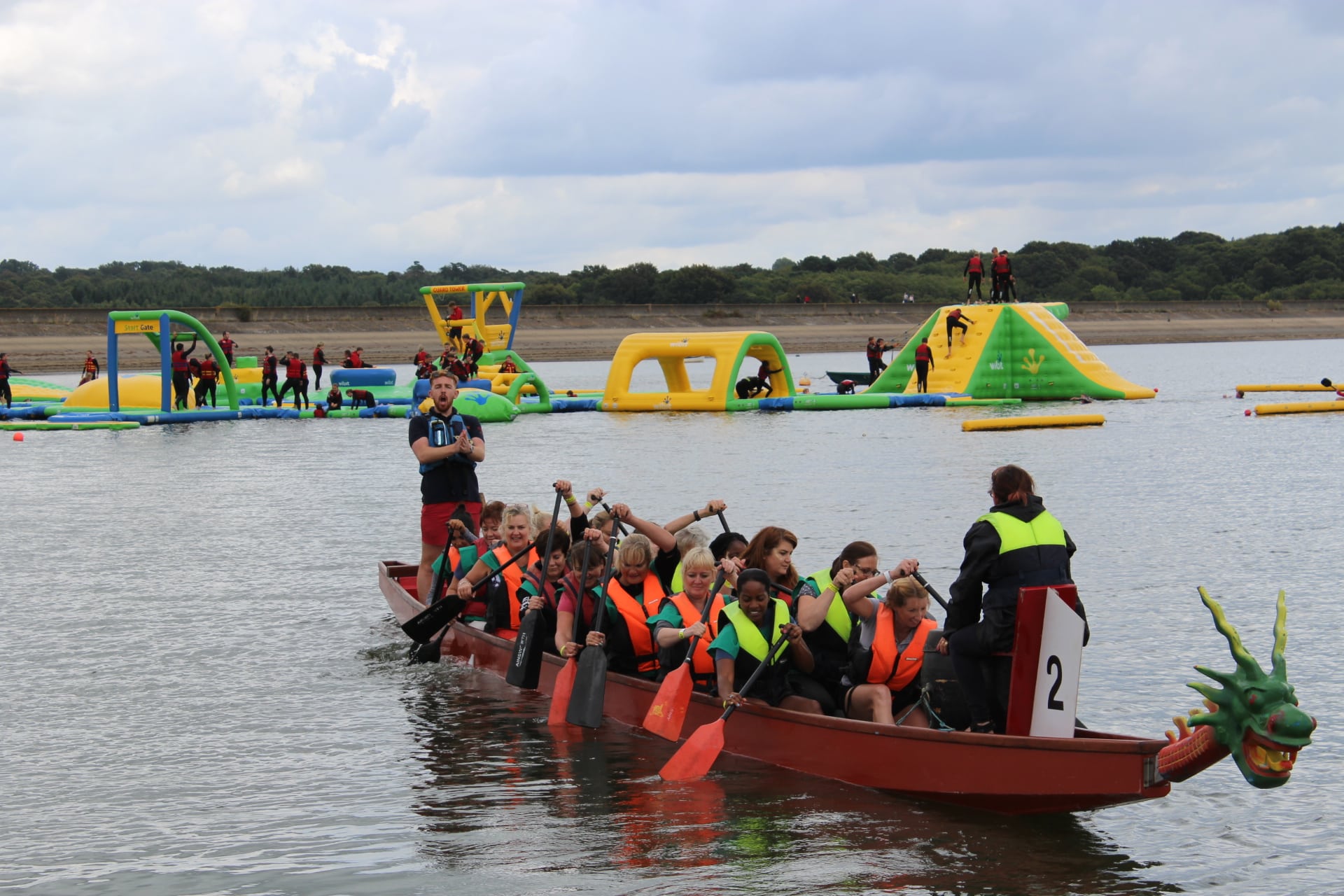 People Participating in the Dragon Boat Race Festival with Aqua Park in the background