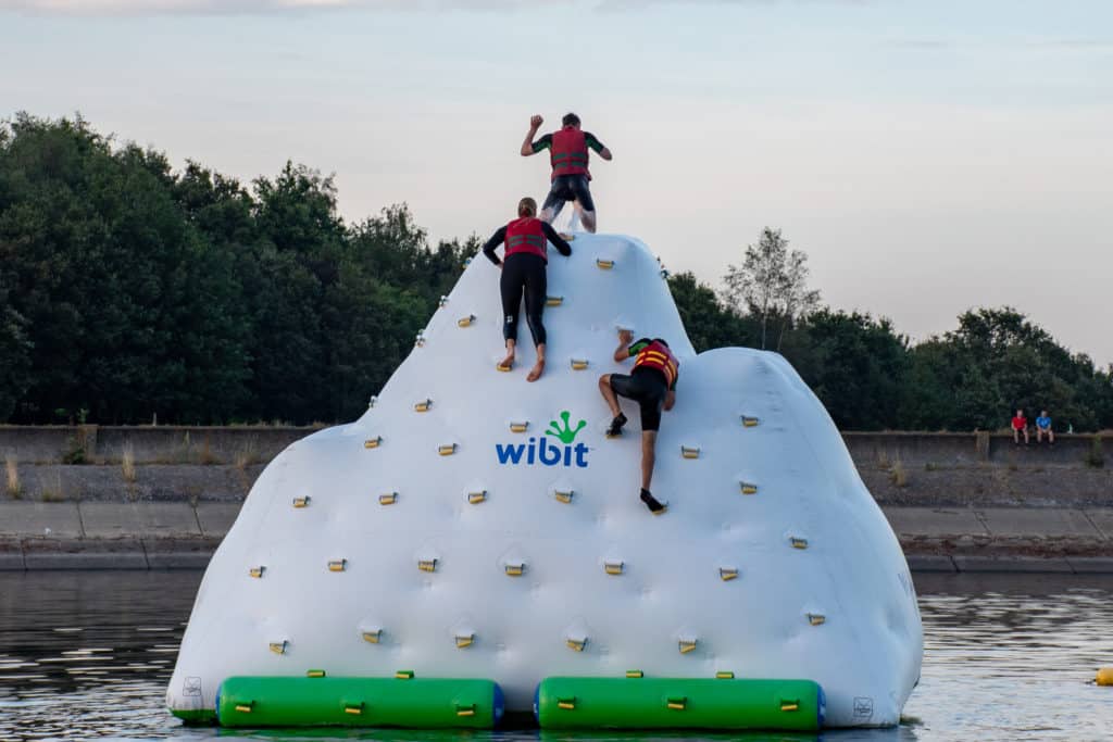 People climbing a wibit climbing wall