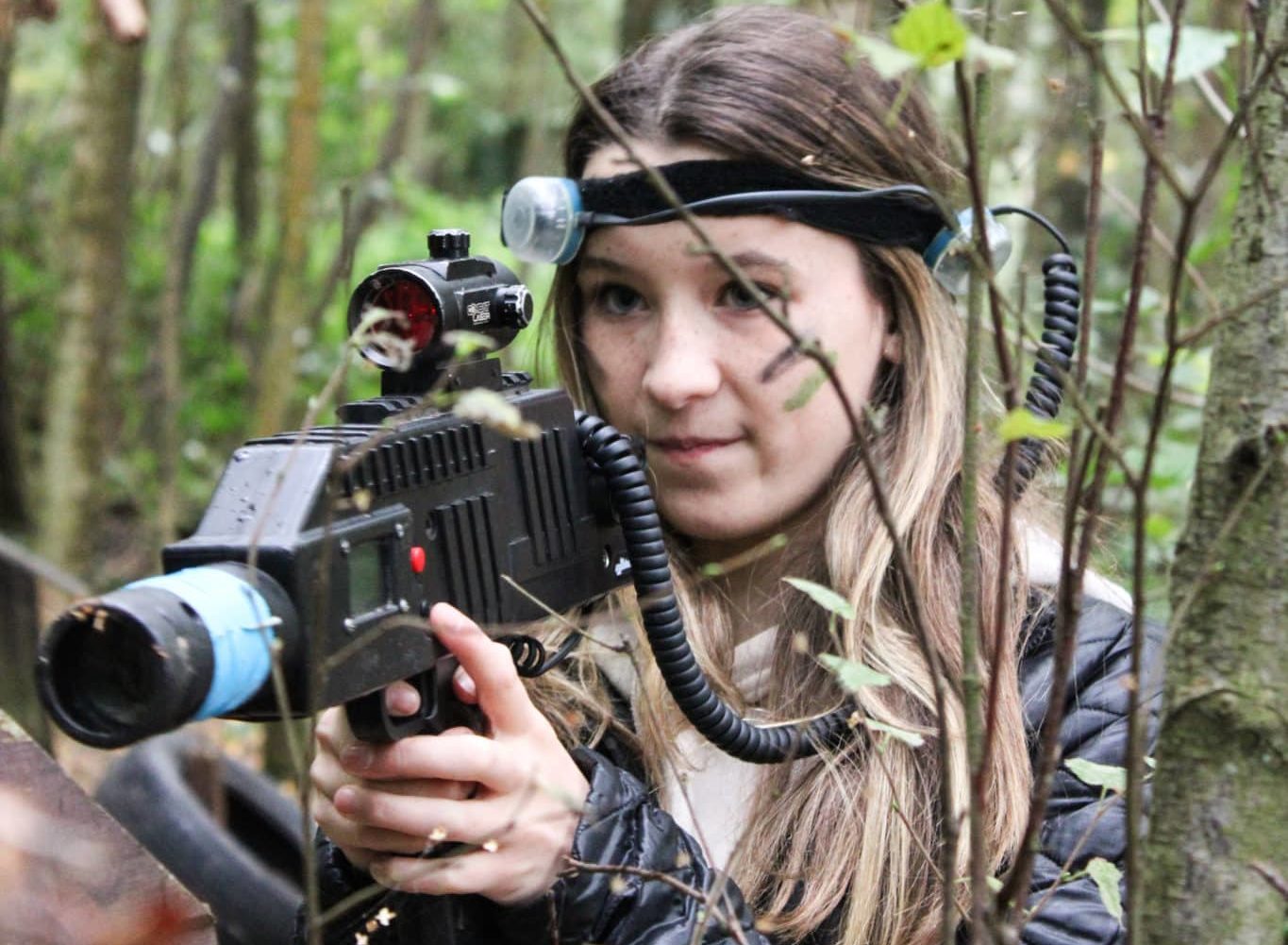 Teenager pointing a laser tag gun