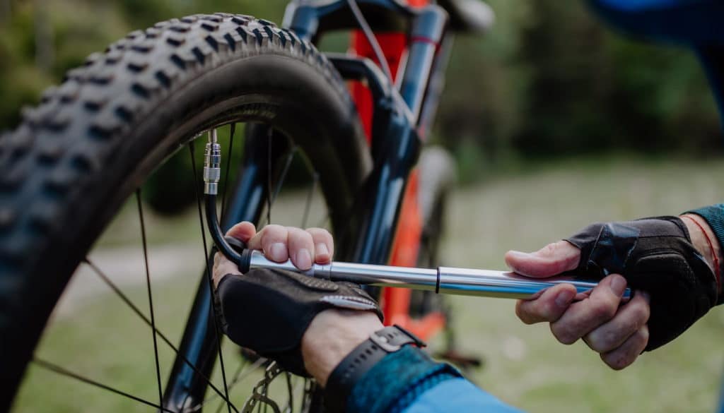 Person fixing bicycle wheel