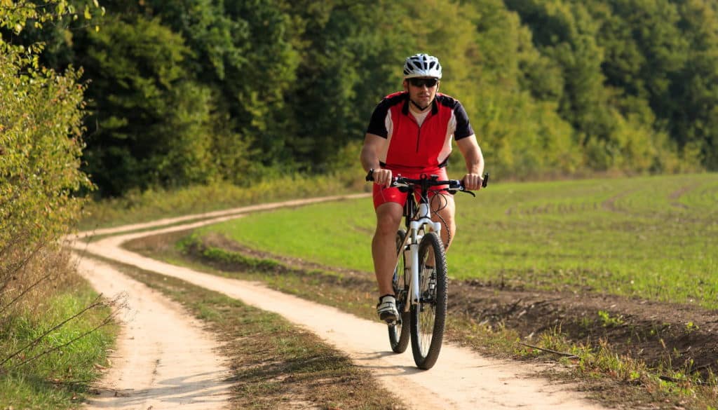 Man cycling with red cycling uniform