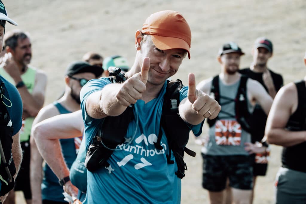 Smiling marathon runner giving double thumbs up before the start of the Bewl Water race in Kent.