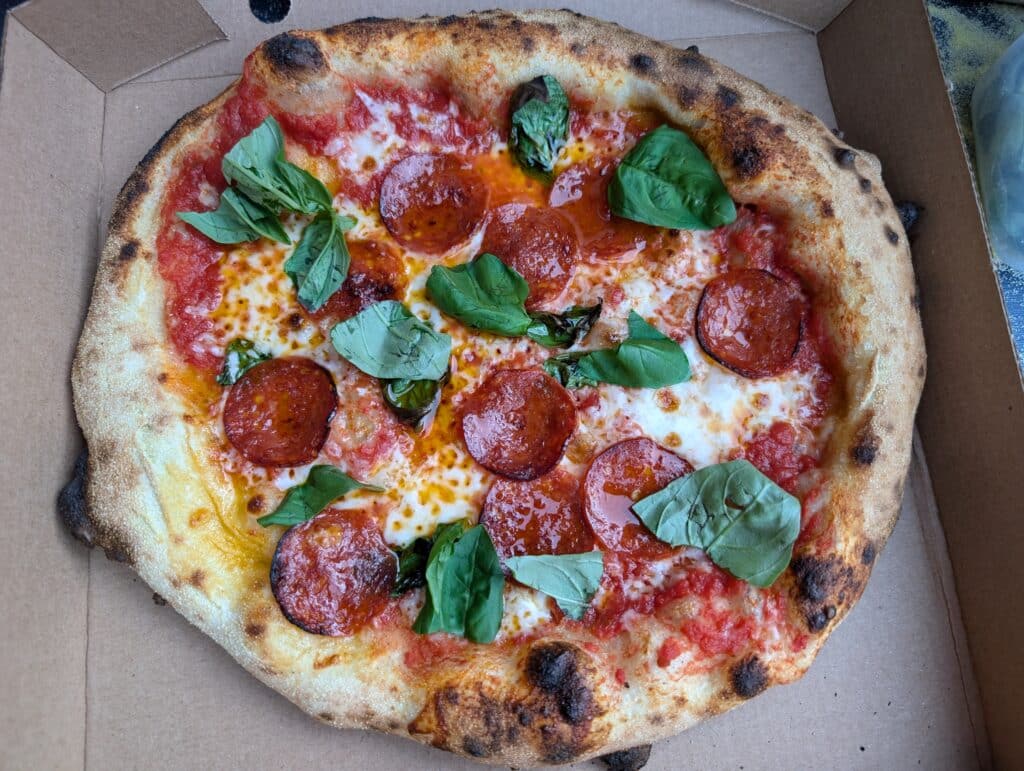 Freshly baked wood-fired pepperoni and basil pizza at Bewl Water, Kent – ideal post-swim food for open water swimmers in the heart of Kent.